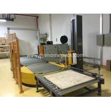Unmanned pallet wrapping machine with powered conveyor